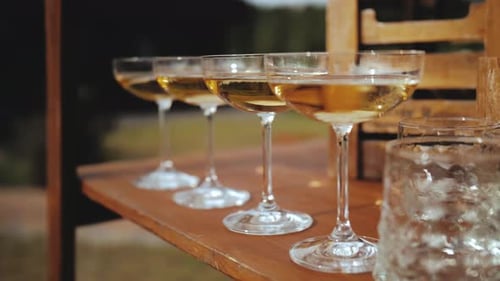 Serving a Buffet with Four Glasses of Champagne Pouring Sparkling Wine in Champagne Glasses Event