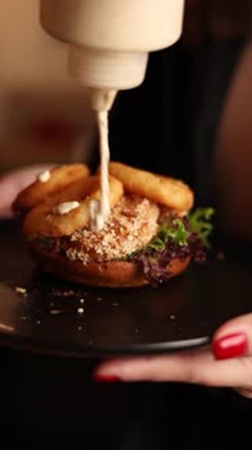 delicious hamburger with cutlet, cheese, cabbage, breaded squid rings. Close up