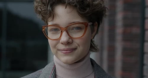 Smiling Young Woman in Glasses Close Up