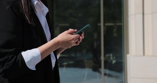 Close Up of Woman Holding Smartphone Surfing Using Mobile Apps for Online Shopping e Learning