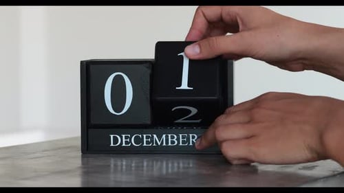 Hand Turns Calendar to December 2nd
