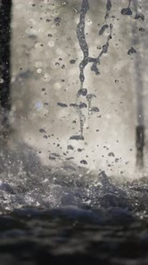 Closeup View of Sparkling Water Droplets in Air Splashing Out of Fountain