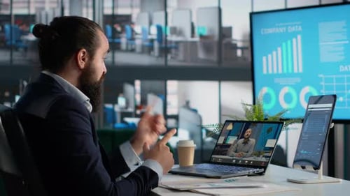 Man video conferencing at modern office workplace