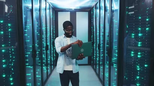 Man with laptop in modern data center