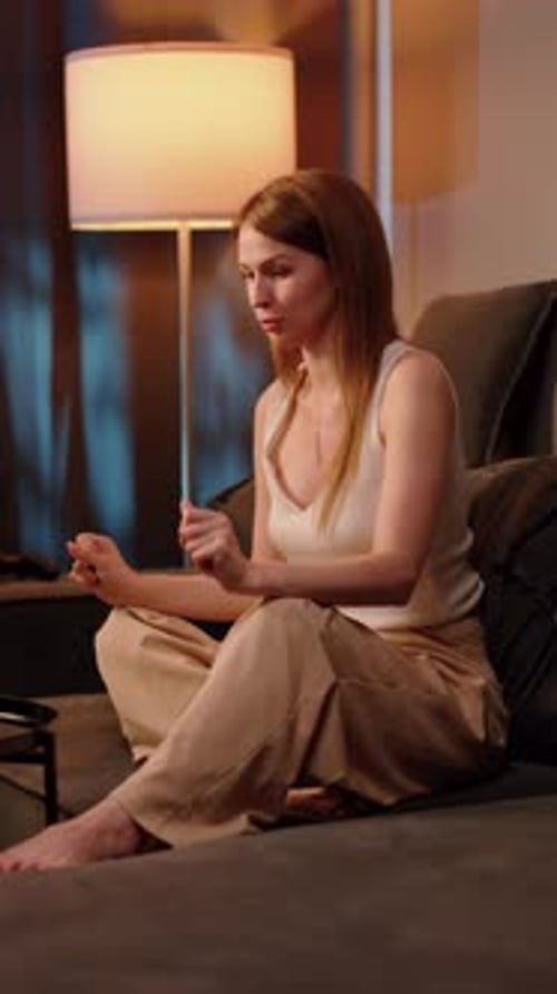 Woman Gesturing During Video Call on Sofa at Home