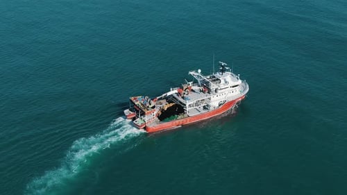 Lonely Fishing Boat Sails on the Sea with Nets on Board Aerial View