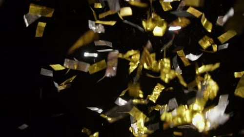Dozens Of Falling Confetti On A Black Background