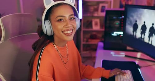 Smiling Woman Playing Video Game on Computer