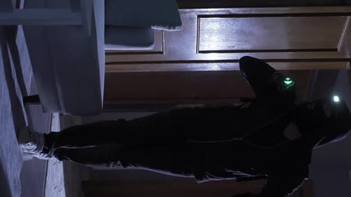 Figure Climbing Ladder in Dark Room