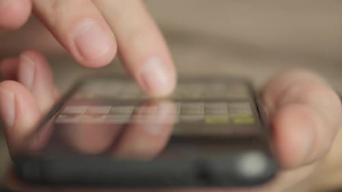 Hand Scrolling Through Content on Smartphone Screen