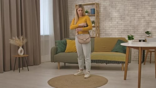 Young Woman Counting Cash in Cozy Living Room Setting