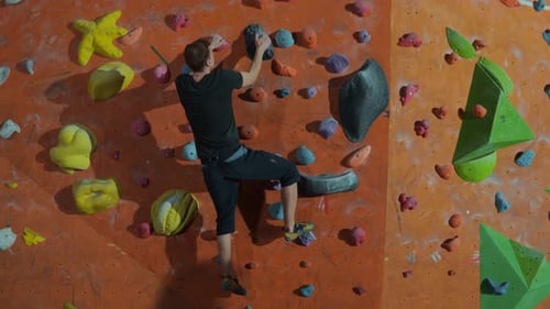 Young Man Indoor Rock Climbing For Fitness