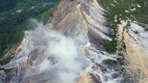 Fly over aerial shot of steam coming from the stratovolcano Mount Sibayak in North Sumatra, Indonesi