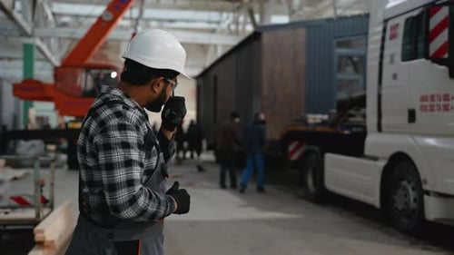 Indian Worker Coordinating Modular Home Loading Process