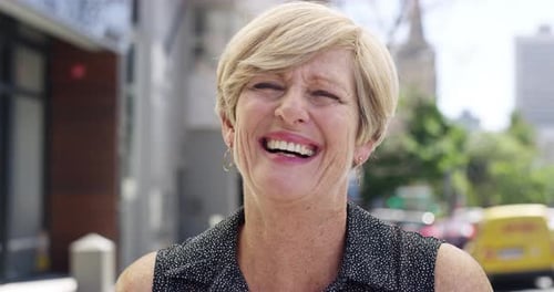 4k video footage of a mature woman laughing while out in the city