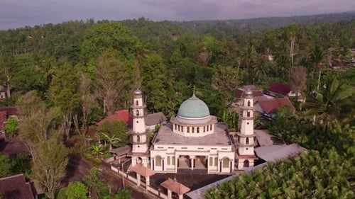 Aerial view of greenery and mosque with Mount Semeru, Indonesia.