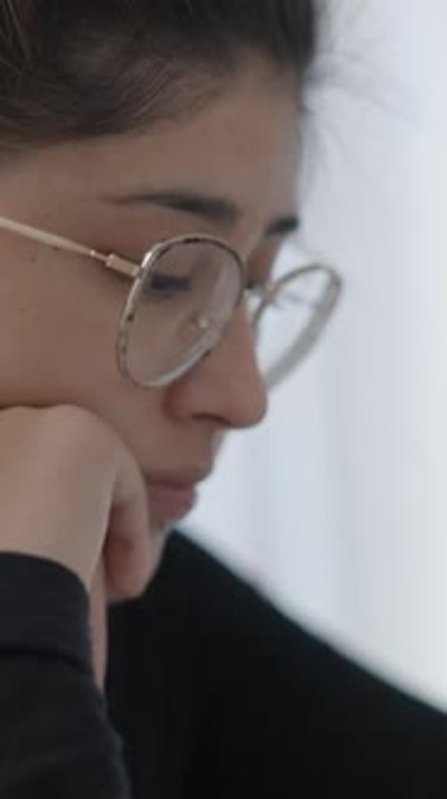 Close Up Shot of a Young Collage Girls Face Wearing Round Shape Glasses While Studying at Home