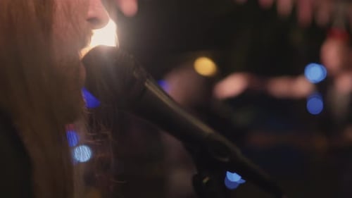 Unrecognizable Vocalist Sings Against Band and Dancing Crowd Close Up
