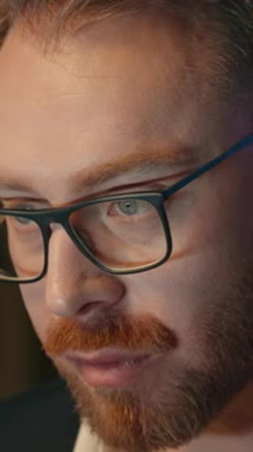 Business Man in Dark Office Writing Notes in Papers Looking in Computer Screen Workaholic Working