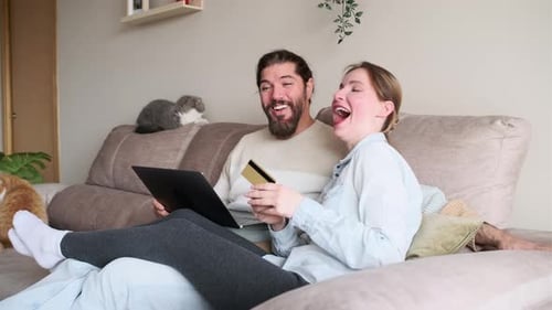 Couple Shopping Online with Laptop at Home