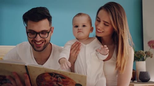 Loving Family Reading a Book to Baby Together