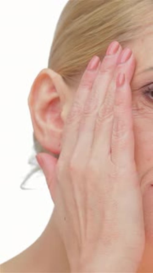 Woman Massaging Cream into Her Face