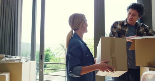 Couple, box and moving in new home, property or real estate together for relocation or renovation