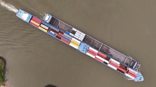 The Vrido Cargo Ship is Sailing Along the River in Alblasserdam, South Holland, Netherlands - Aerial
