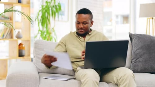 Man Working on Laptop at Home