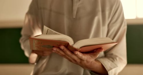 Hands, man in mosque reading Quran and Islamic study of mindfulness, gratitude and faith