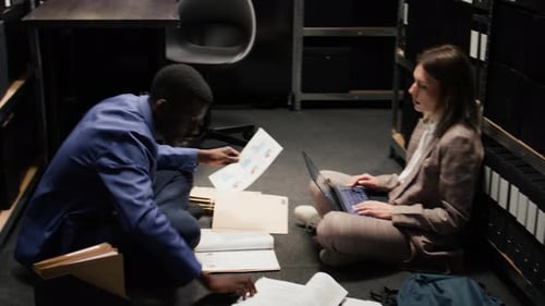 Colleagues Work with Files on Office Floor