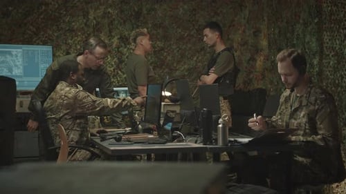 Team of Military Officers Co-working at Night Office