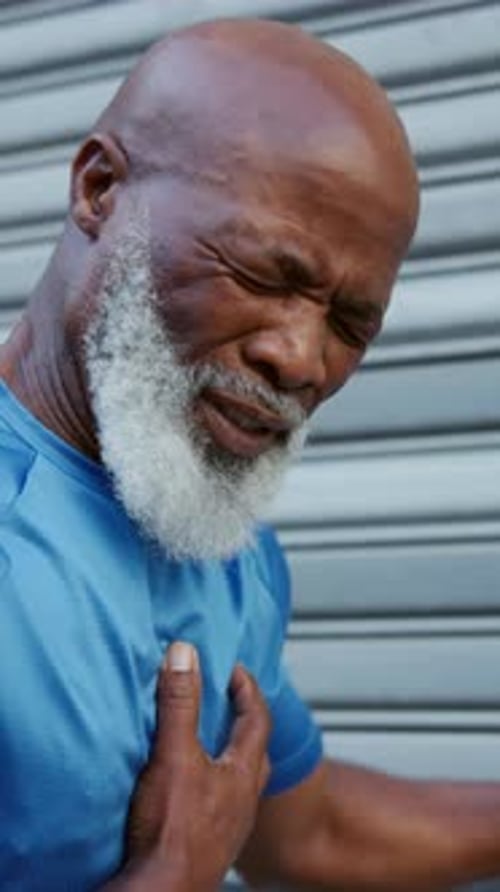 Fitness, chest pain and black man with heart attack, injury and angina outdoor in city