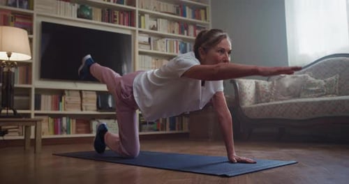 Senior Woman Doing Arm and Leg Exercises at Home