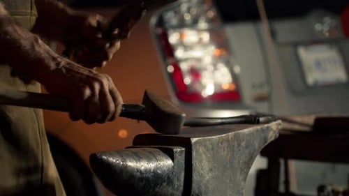 Blacksmith is Using Hammer to Forge Metal Closeup of a Man Making Handicrafts