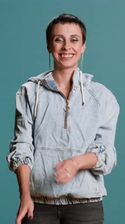 Smiling Woman in Denim Jacket Poses Confidently