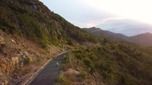 Aerial Tracking of a Motorist Traveling on the Scenic Mountains Road at Ssunset