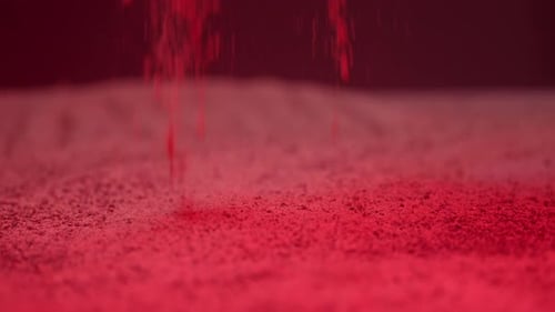 Red Powder Falling on Surface