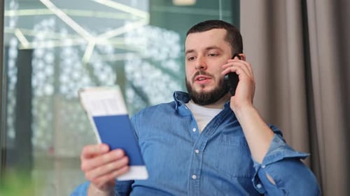 Traveler Making Phone Call With Passport And Boarding Pass