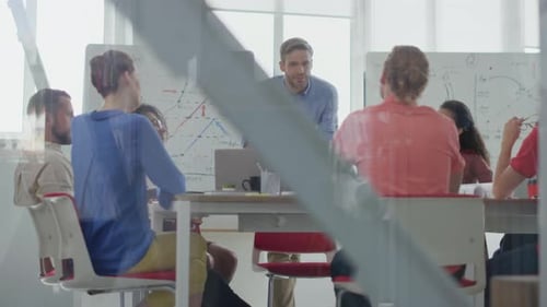Through Glass View Confident Business Leader Talking with Colleagues in Meeting Room