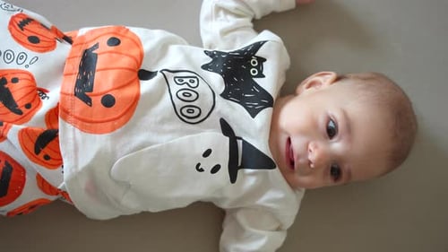 Cute Infant Lying Down Wearing Halloween Outfit
