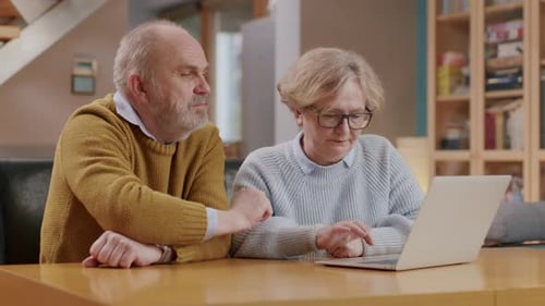 Mature Couple Using Laptop at Home