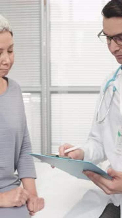 Patient Listening to Doctor in Hospital Room
