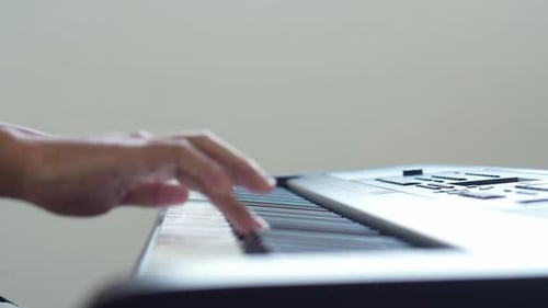 Side view Of Man Playing Piano Keyboard