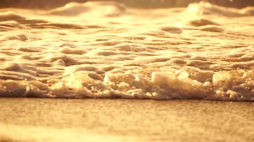 Small Sea Wave Blurred Soft Foamy Waves Washing Golden Sandy Beach on Sunset