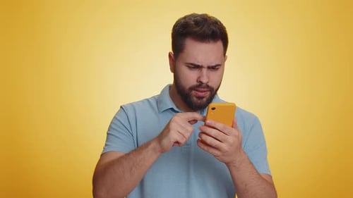 Upset Man Using Smartphone With Frustration