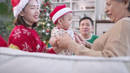 Christmas Family Celebration with Baby in Santa Hat
