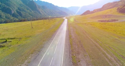 Flight Over Mountain Asphalt Highway Road and Meadow