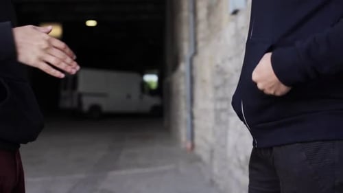 Addict buying heroin dose from drug dealer on street exploring addiction and crime