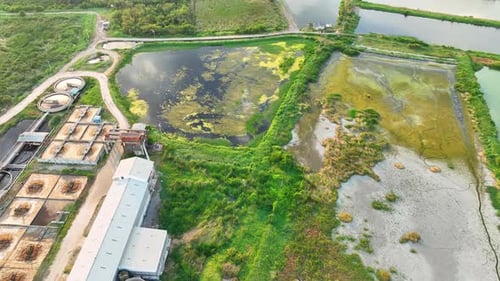 An aerial drone captures industrial wastewater flows into surface water.